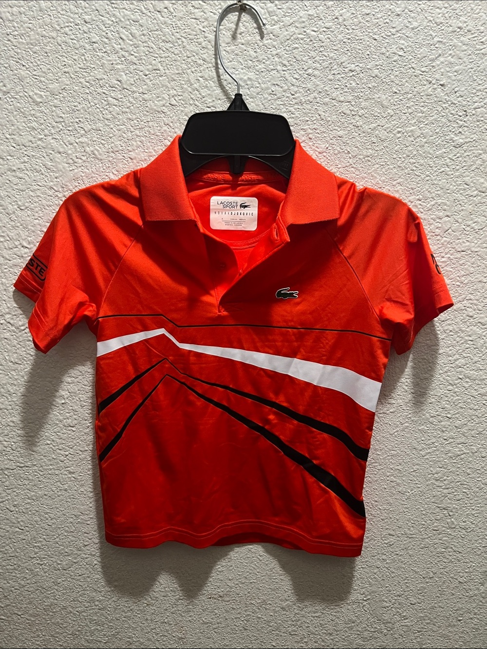 Lacoste Kids Bright Orange Polo with White and Black Graphic Stripes